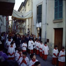 Procession of Corpus altar boys and custody pass through the narrow streets of the town of Poll…