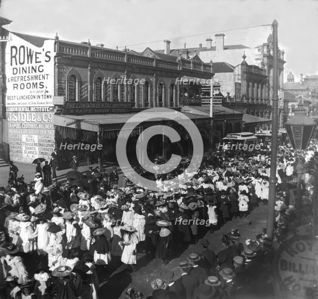 Procession of girls and women out the front of 142, Queen Street corner Edward Street, 1905. Creator: Robert Augustus Henry L'Estrange.