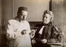 Professor and Mrs Dejerine looking at a microscopic sample of the human brain, c1900s. Creator: Unknown