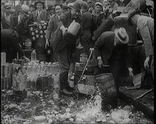 Prohibition Scenes in the United States of America. Men Smashing Bottles of Alcoholic..., 1920. Creator: British Pathe Ltd