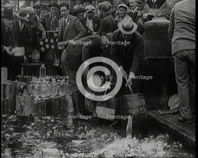 Prohibition Scenes in the United States of America. Men Smashing Bottles of Alcoholic..., 1920. Creator: British Pathe Ltd.