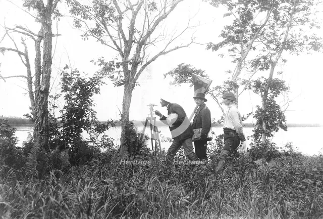 Prospectors conducting a triangulation survey from the bank of the Zeya River, 1909. Creator: Unknown.