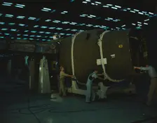 Putting the nose section of a mighty transport...Consolidated Aircraft..., Fort Worth, Texas, 1942. Creator: Howard Hollem