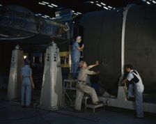Putting the nose section of a mighty transport...Consolidated Aircraft..., Fort Worth, Texas, 1942. Creator: Howard Hollem