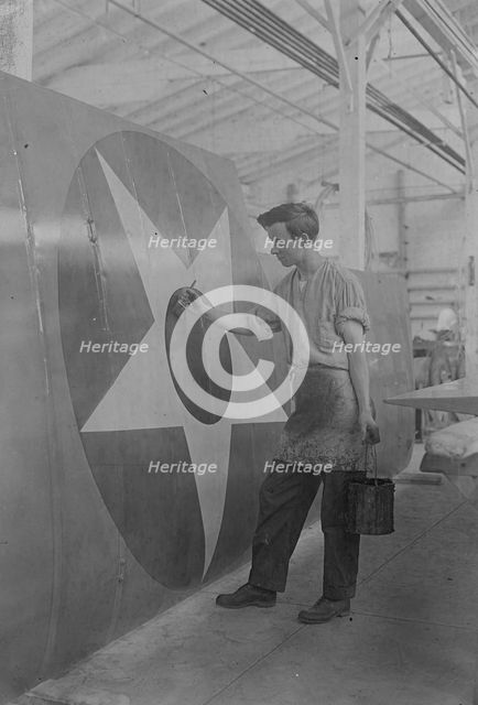 Putting U.S. Emblem on plane, between c1915 and c1920. Creator: Bain News Service.