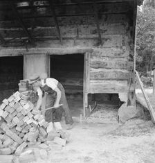Putting in new flues in tobacco barn, Orange County, North Carolina, 1939. Creator: Dorothea Lange