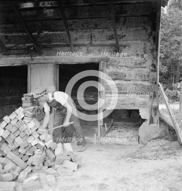 Putting in new flues in tobacco barn, Orange County, North Carolina, 1939. Creator: Dorothea Lange.