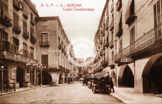 Public vehicles parked on Vi Square, in front of the town hall in Girona, in a postcard from the …