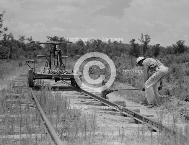 Pulling out the railroad tracks which lead to the closed sawmill, Careyville, Florida, 1937. Creator: Dorothea Lange.