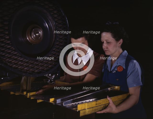 Punching rivet holes in a frame member for a B-25 bomber...North American Aviation, Inc., CA, 1942. Creator: Alfred T Palmer.