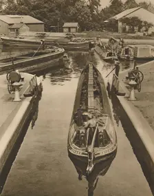 Pushing a Monkey Boat Through The Lock at Brentford c1935. Creator: Unknown