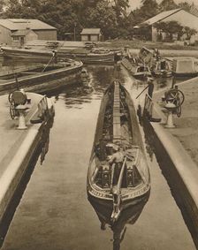 Pushing a Monkey Boat Through The Lock at Brentford c1935. Creator: Unknown