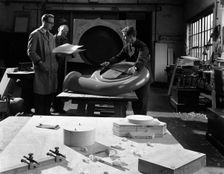 Quality checking a casting for a pump, Rotherham, South Yorkshire, 1963. Creator: Michael Walters