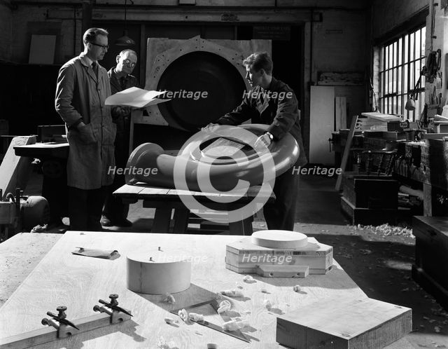 Quality checking a casting for a pump, Rotherham, South Yorkshire, 1963. Creator: Michael Walters.