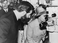 Queen Elizabeth II looks through a periscope at the submarine base at Faslane, Scotland, 1974