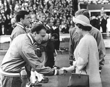 Queen Elizabeth II shaking hands with England footballer George Cohen, World Cup, Wembley, 1966. Creator: Unknown