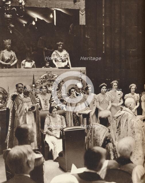 'Queen Elizabeth looks on as her husband is crowned on the day of his coronation', 1937. Creator: Unknown.