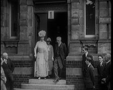 Queen Mary Accompanied by a Group of Officials Emerging from a Building , 1924. Creator: British Pathe Ltd