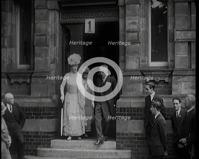 Queen Mary Accompanied by a Group of Officials Emerging from a Building , 1924. Creator: British Pathe Ltd.