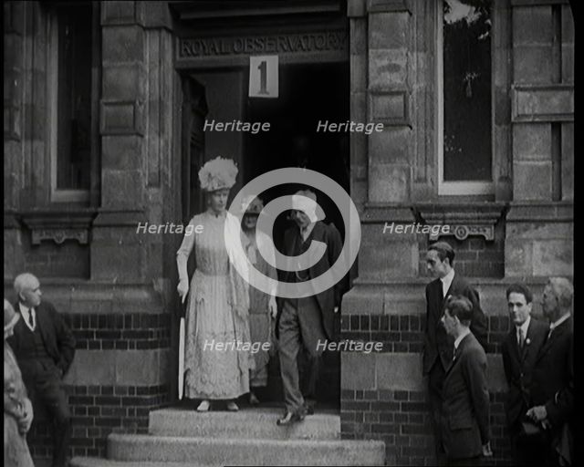 Queen Mary Accompanied by a Group of Officials Emerging from a Building , 1924. Creator: British Pathe Ltd.