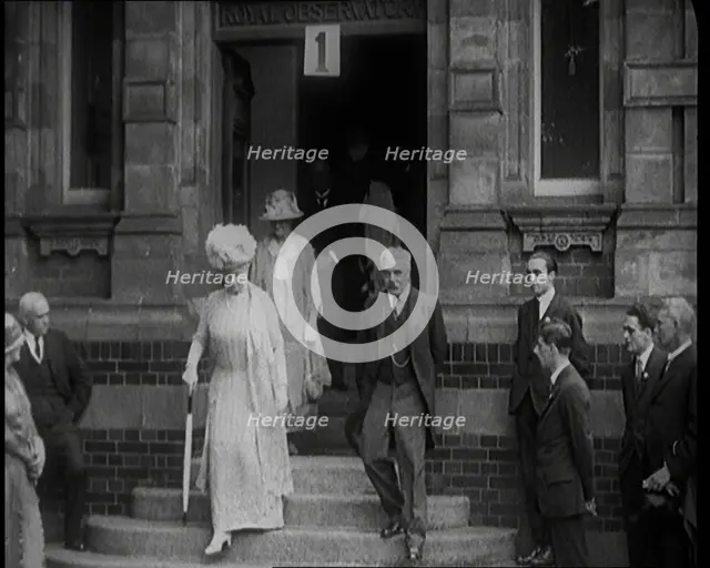Queen Mary Accompanied by a Group of Officials Emerging from a Building , 1924. Creator: British Pathe Ltd.