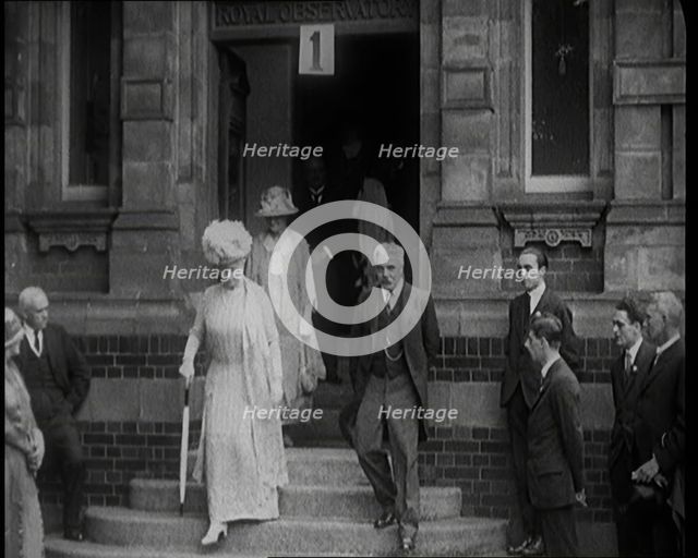 Queen Mary Accompanied by a Group of Officials Emerging from a Building , 1924. Creator: British Pathe Ltd.