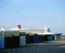 Queen Mary II sails past Beach Huts, Calshot May 2004