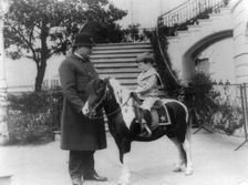 Quentin Roosevelt on pony beside White House policeman, 1905. Creator: Frances Benjamin Johnston