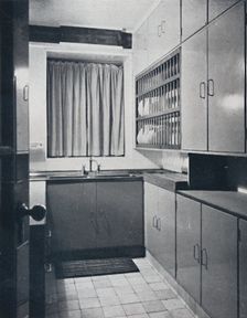 R. W. Symonds and Partner, L. & A.R.I.B.A. - Kitchen: Putty-coloured cellulosed fiitments, stainles