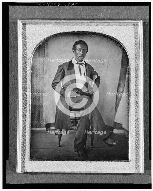 R. McGill, full-length portrait, seated in chair, facing front, with..., between 1840 and 1860. Creator: Unknown.