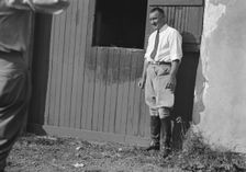 Rothbart, Albert, Mr., grounds, with unidentified man standing by a stable door, c1920-1935. Creator: Arnold Genthe