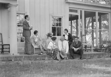 Rothbart, Albert, Mr., group, seated on a porch, between 1920 and 1935. Creator: Arnold Genthe