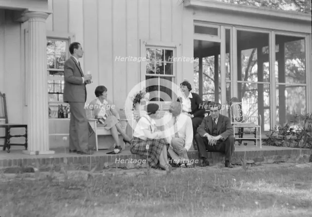 Rothbart, Albert, Mr., group, seated on a porch, between 1920 and 1935. Creator: Arnold Genthe.