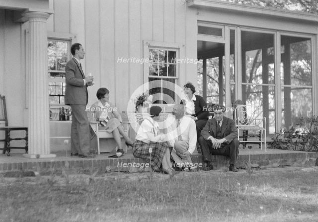 Rothbart, Albert, Mr., group, seated on a porch, between 1920 and 1935. Creator: Arnold Genthe.