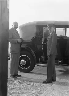 Rothbart, Albert, Mr., standing by his car with his chauffeur, between 1920 and 1935. Creator: Arnold Genthe