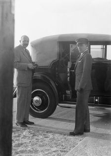 Rothbart, Albert, Mr., standing by his car with his chauffeur, between 1920 and 1935. Creator: Arnold Genthe