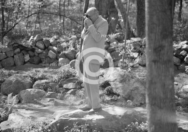 Rothbart, Albert, Mr., taking a photograph outdoors, between 1920 and 1935. Creator: Arnold Genthe.