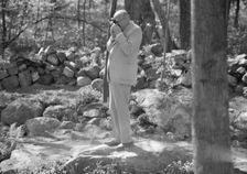Rothbart, Albert, Mr., taking a photograph outdoors, between 1920 and 1935. Creator: Arnold Genthe