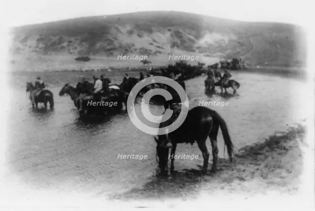 Rough riders on horseback in water at Montauk Point, 1898. Creator: Frances Benjamin Johnston.