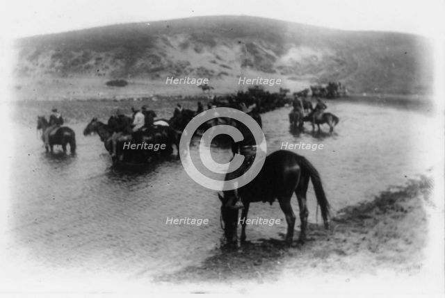 Rough riders on horseback in water at Montauk Point, 1898. Creator: Frances Benjamin Johnston.