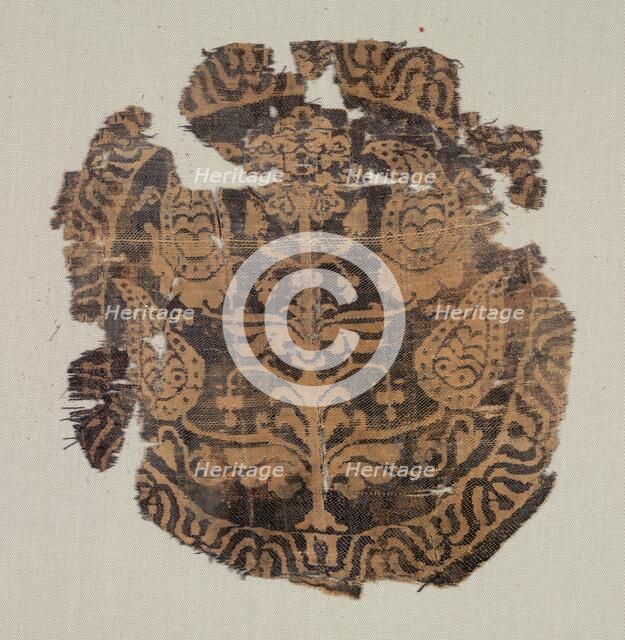 Roundel with curvilinear palmette tree, from a tunic, 600-850. Creator: Unknown.