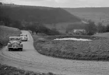 Rover of BN Wilmott and Jaguar SS of Dr AR Gray competing in the RAC Rally, 1939. Artist: Bill Brunell