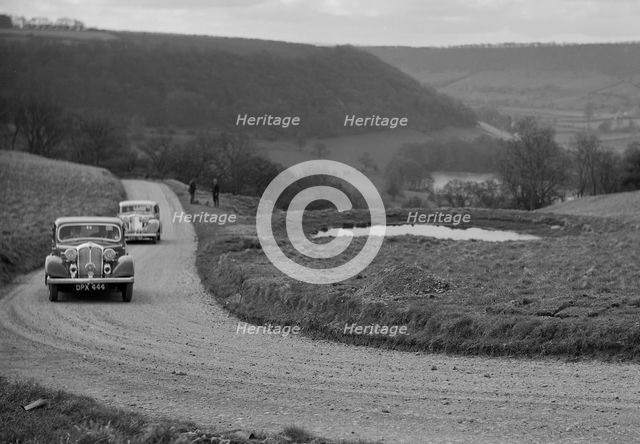 Rover of BN Wilmott and Jaguar SS of Dr AR Gray competing in the RAC Rally, 1939. Artist: Bill Brunell.