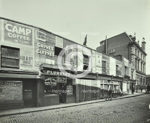 Row of shops with advertising hoardings, Balls Pond Road, Hackney, London, September 1913. Artist: Unknown.