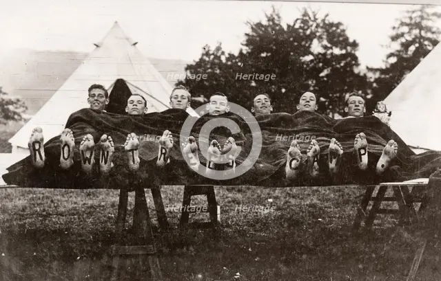 Rowntree boys at camp lie on a trestle,Coniston, Cumbria,  summer 1913. Artist: Unknown