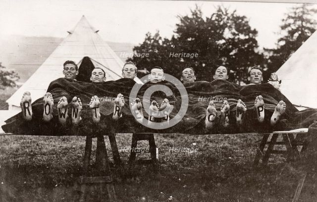 Rowntree boys at camp lie on a trestle,Coniston, Cumbria,  summer 1913. Artist: Unknown