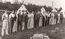 Rowntree boys line up for inspection outside their tents, Coniston, Cumbria, summer 1913