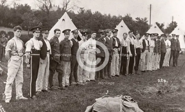 Rowntree boys line up for inspection outside their tents, Coniston, Cumbria, summer 1913. Artist: Unknown