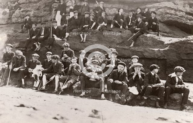 Rowntree boys on an outing sit on a rocky outcrop ,Filey Brig, Yorkshire, June 1911. Artist: Unknown