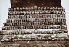 Rows of decorated pharmacy jars and other objects, c19th century. Creator: Unknown